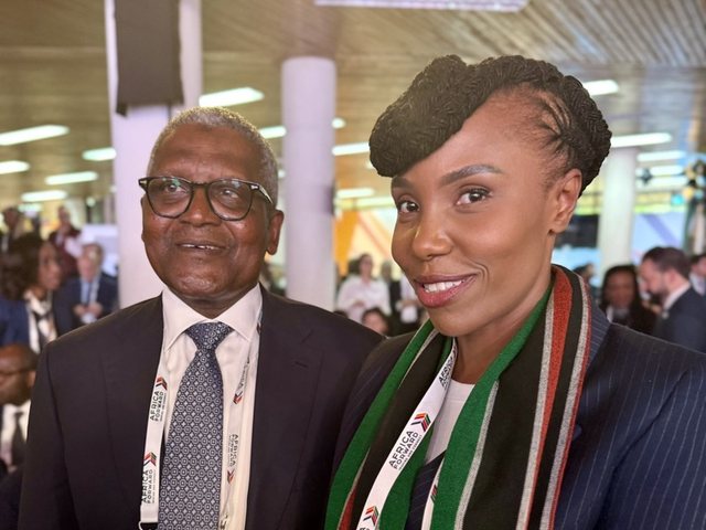 Olivia Otieno with a fellow delegate at an international conference, wearing a Kenyan flag scarf
