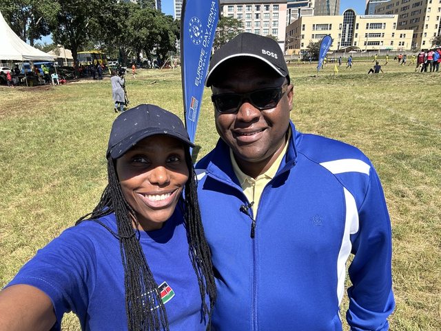 Olivia Otieno and a guest in caps at the Europe Day Kenya Football Tournament
