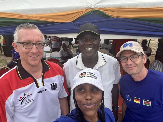 Olivia Otieno taking a selfie with three men at a Kenya and Germany friendship event