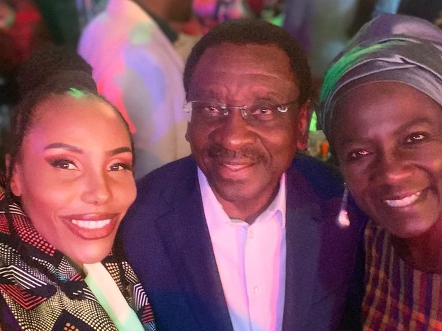 Olivia Otieno taking a selfie with two guests at an evening event