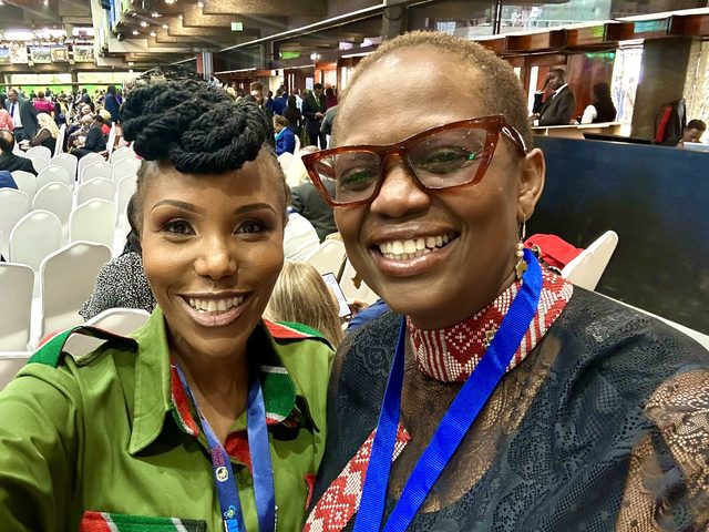 Olivia Otieno taking a selfie with a delegate in the hall at the Africa Climate Summit