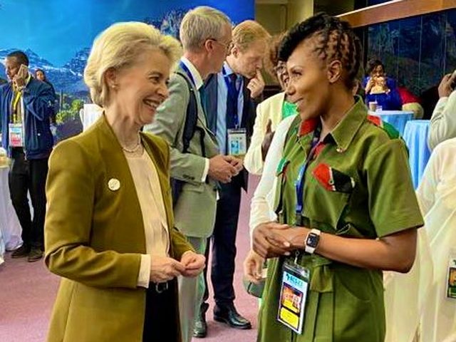 Olivia Otieno in conversation with a guest at an international summit