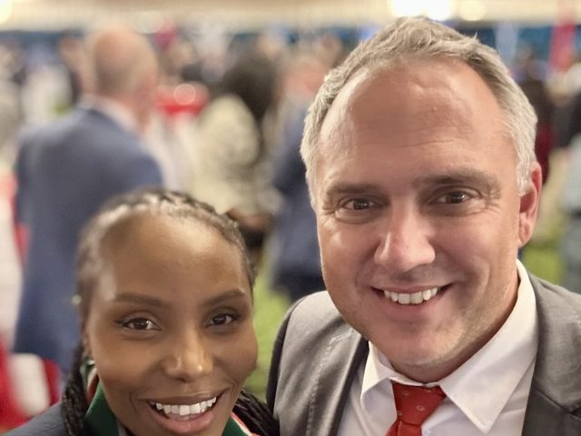 Olivia Otieno taking a selfie with a guest at an evening reception